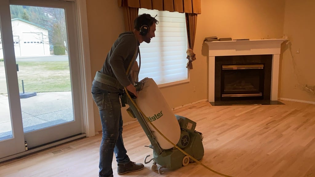 Lagler edger sander in active use during hardwood refinishing, North Idaho