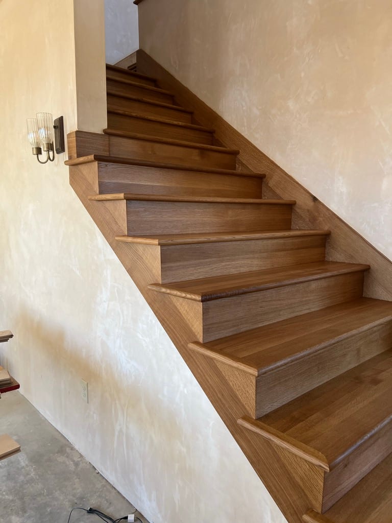 Modern oak staircase installation in plaster-walled home, Hayden Idaho