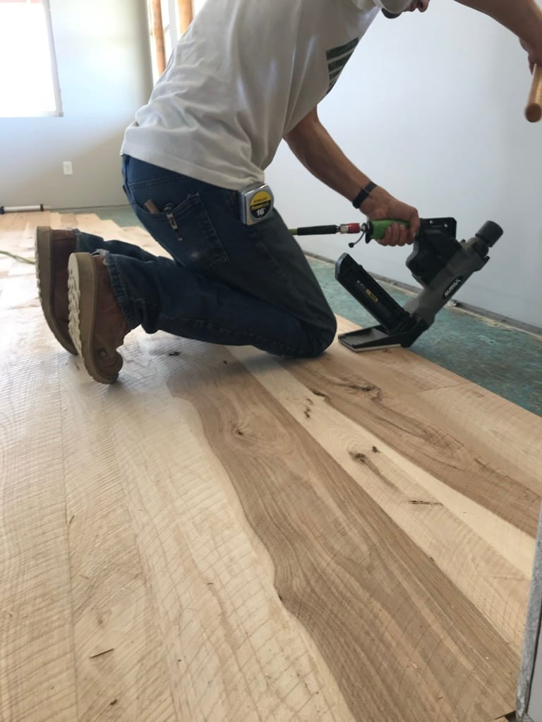 Craftsman installing hardwood floor with pneumatic nailer, Hayden Idaho