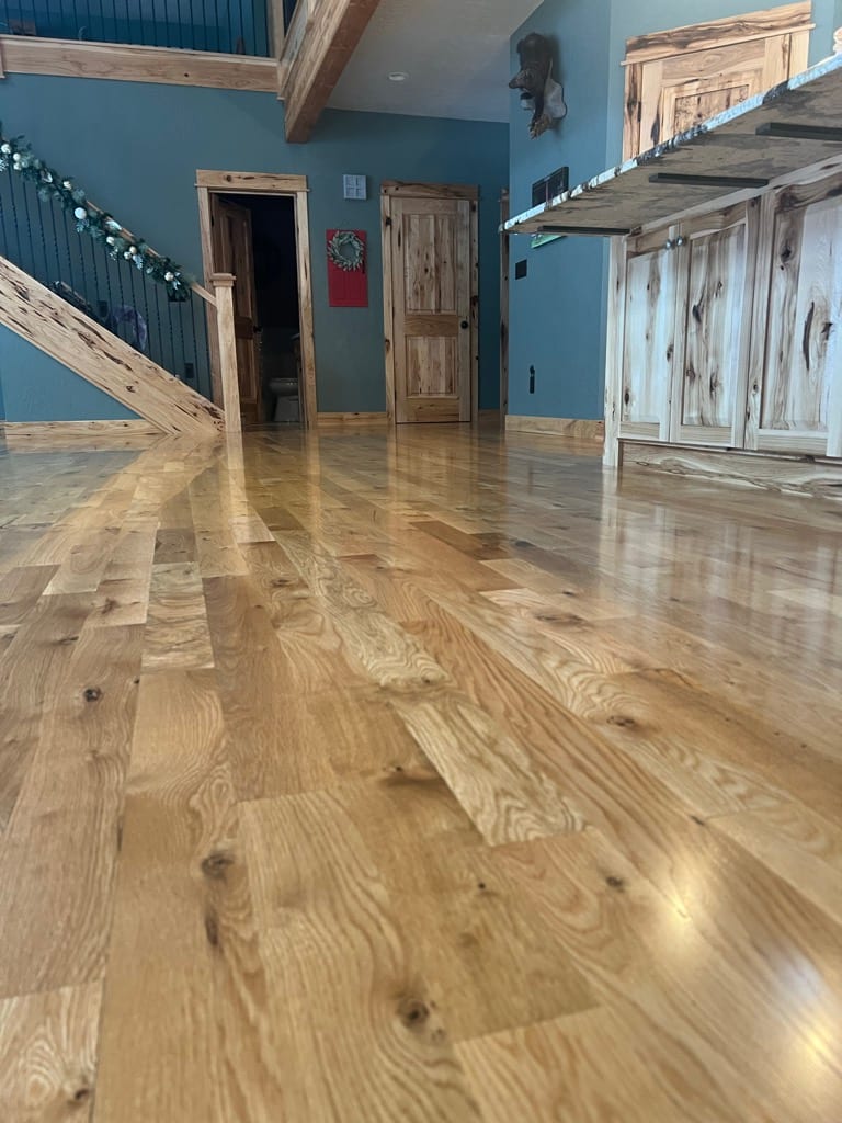 Wide-plank hickory hardwood floor in log-home great room, Hayden Idaho