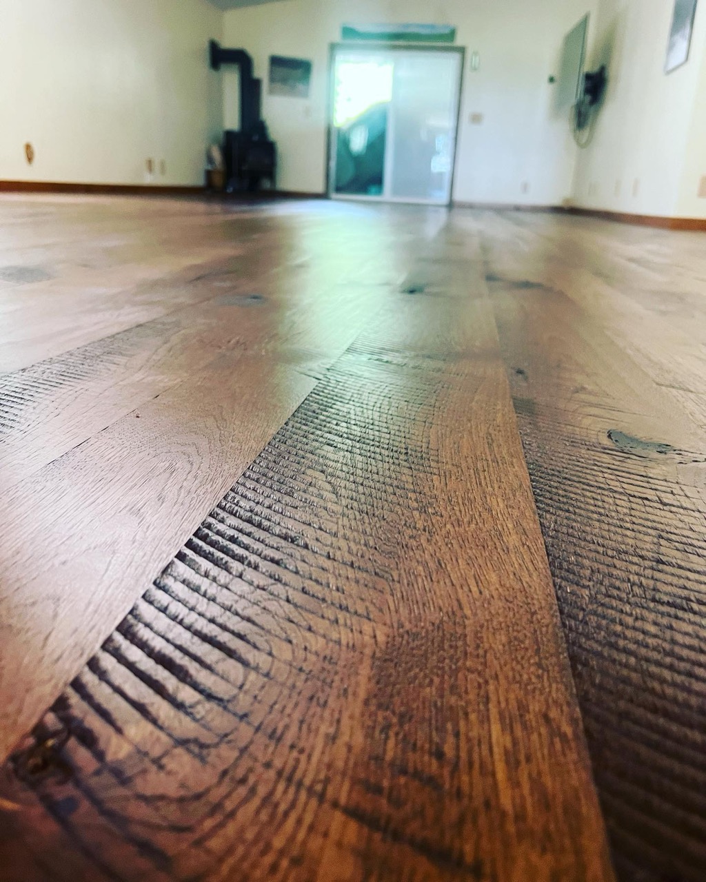 Circle-sawn wide-plank hardwood floor showing saw-mark texture